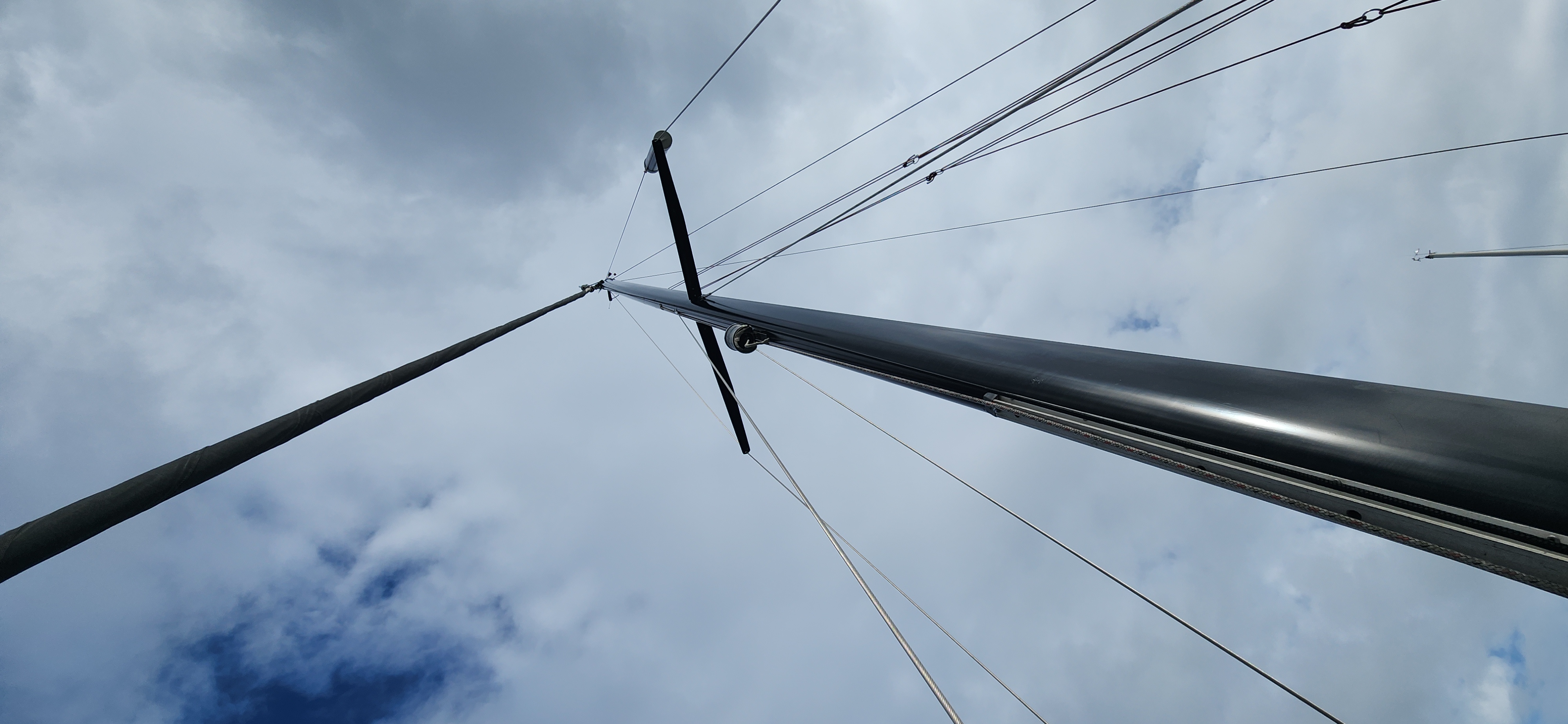 Looking up a sailing mast against the sky