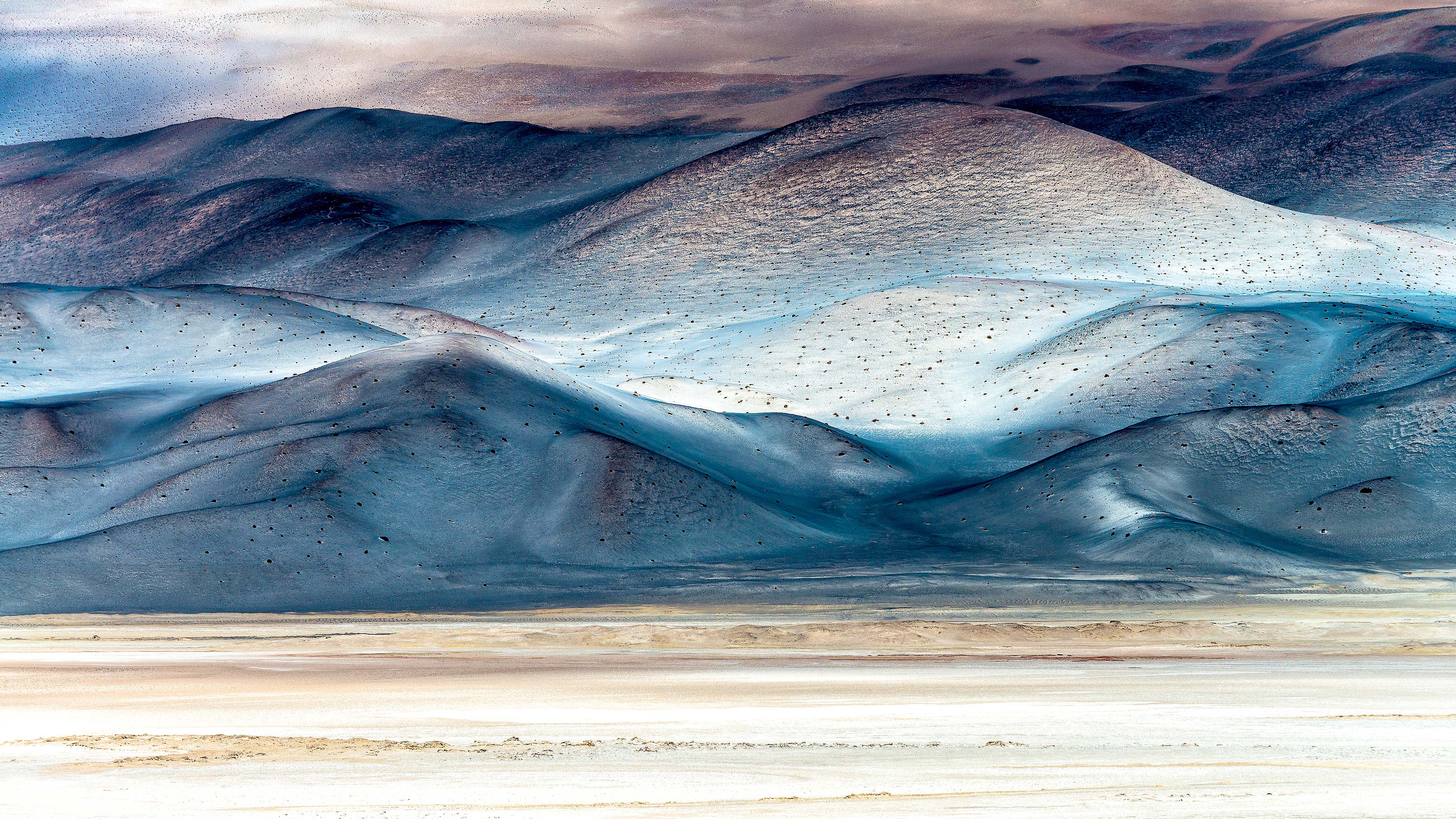 Layered desert mountain ranges receding into haze